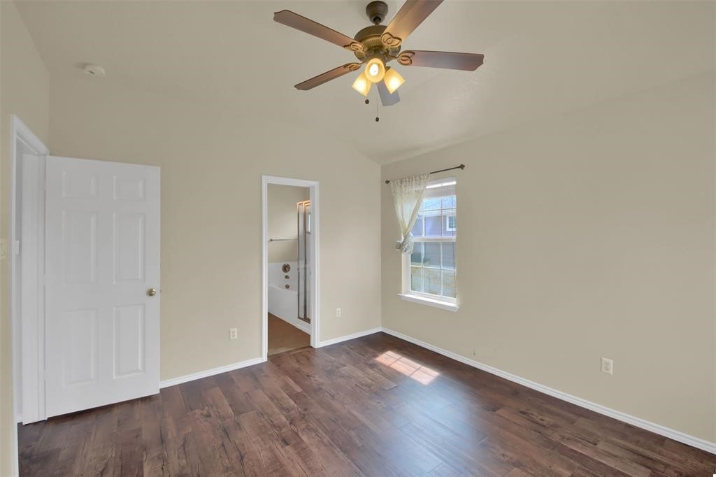 1900 Scofield Ridge Parkway, Unit 3401 Austin, TX 78727 - Photo 25 of 37 an empty room with wooden floor chandelier fan and windows