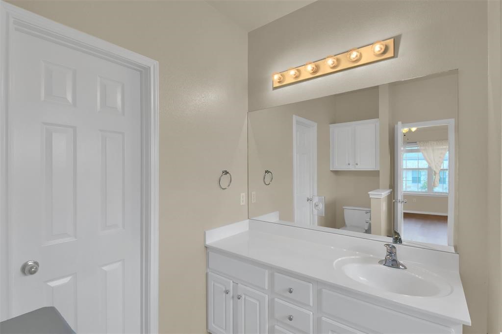1900 Scofield Ridge Parkway, Unit 3401 Austin, TX 78727 - Photo 30 of 37 a bathroom with a sink a vanity and a mirror