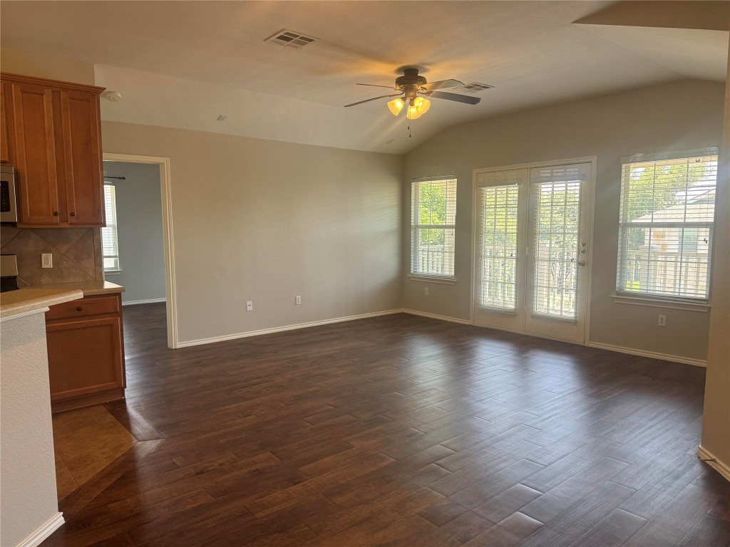1900 Scofield Ridge Parkway, Unit 3401 Austin, TX 78727 - Photo 9 of 37 a view of an empty room with wooden floor and a window