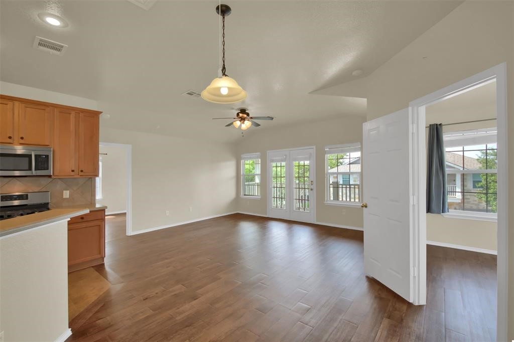 1900 Scofield Ridge Parkway, Unit 3401 Austin, TX 78727 - Photo 10 of 37 a view of an empty room with window and wooden floor