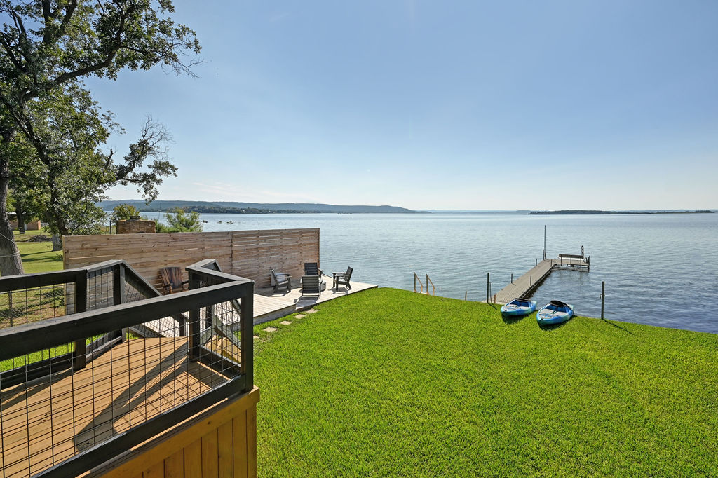 611 Lakeshore Loop Tow, TX 78672 - Photo 22 of 40 View of green lawn with a water view and a boat dock