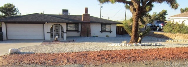 13180 Waco Road Apple Valley, CA 92308 - Photo 1 of 1 a front view of a house with garden