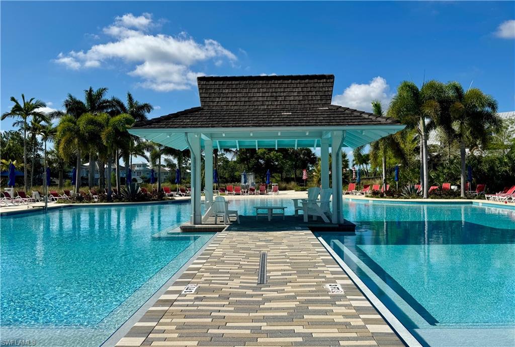6466 Warwick Avenue Naples, FL 34113 - Photo 33 of 43 a view of a swimming pool with a patio