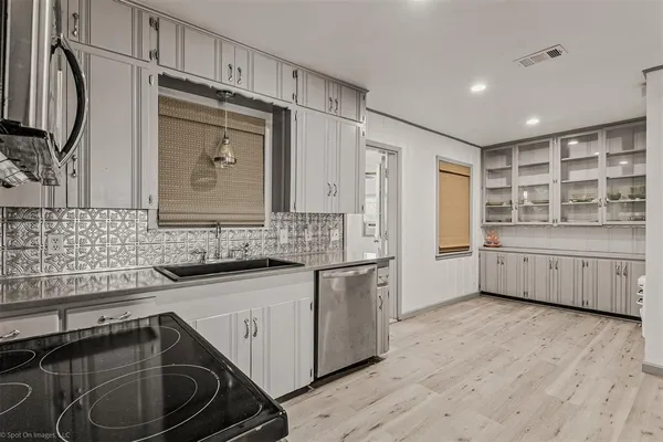 a kitchen with stainless steel appliances a sink and cabinets