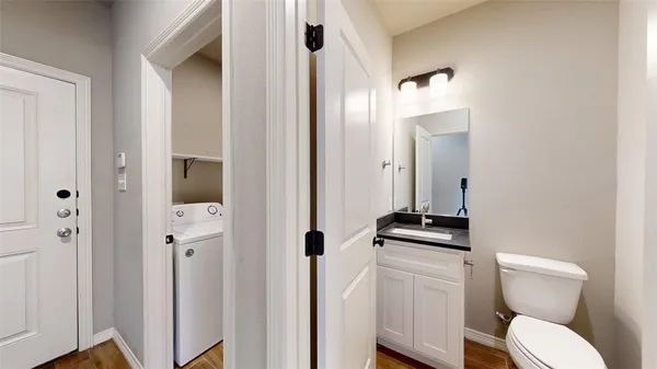 a bathroom with a toilet a sink and mirror