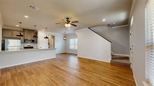 a view of kitchen with cabinets and wooden floor
