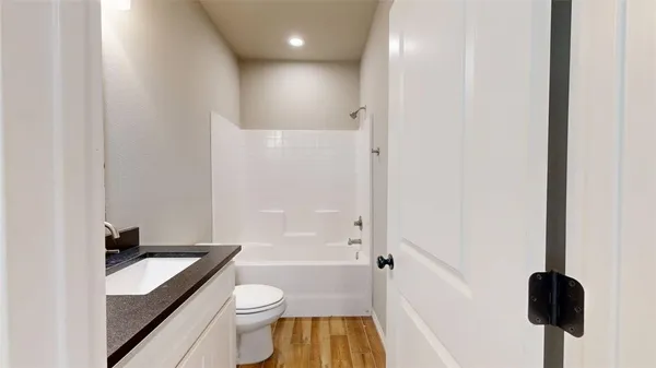 a bathroom with a toilet a sink and bathtub