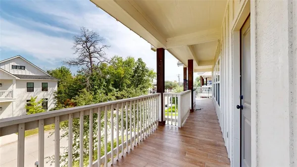 a view of a balcony with wooden floor