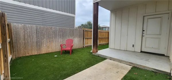 a backyard of a house with table and chairs