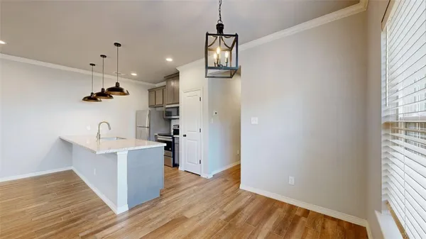 a view of hallway with wooden floor and windows
