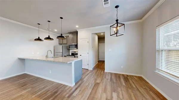 a view of a kitchen with a sink stainless steel appliances and cabinets
