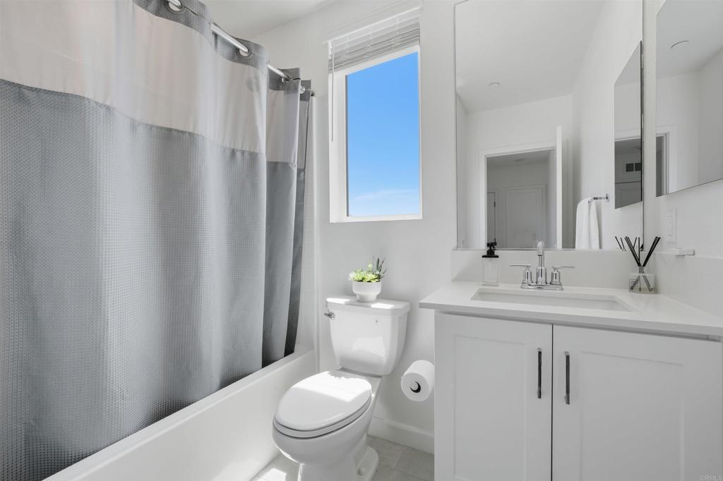 2402 Cascalote Loop San Diego, CA 92154 - Photo 29 of 35 a bathroom with a sink a toilet and shower