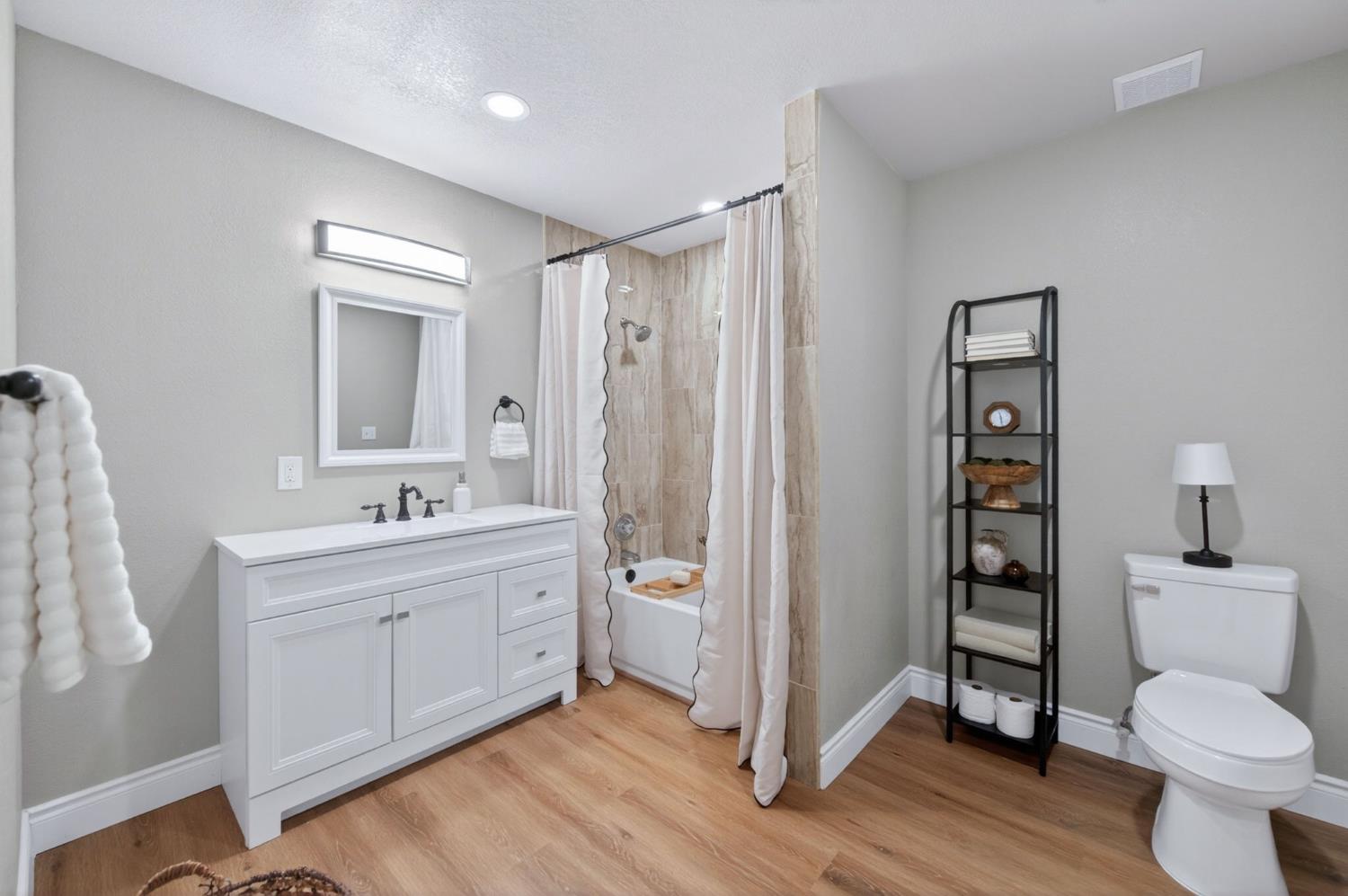 16564 Monreal Road Madera, CA 93636 - Photo 43 of 59 a bathroom with a toilet a sink and mirror