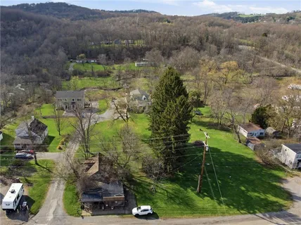 an aerial view of mountain with residential house