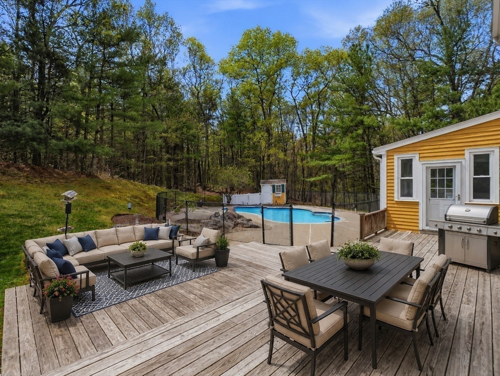 10 Hawk Ridge Road Andover, MA 01810 - Photo 29 of 32 a view of a patio with table and chairs and couches with wooden floor and fence