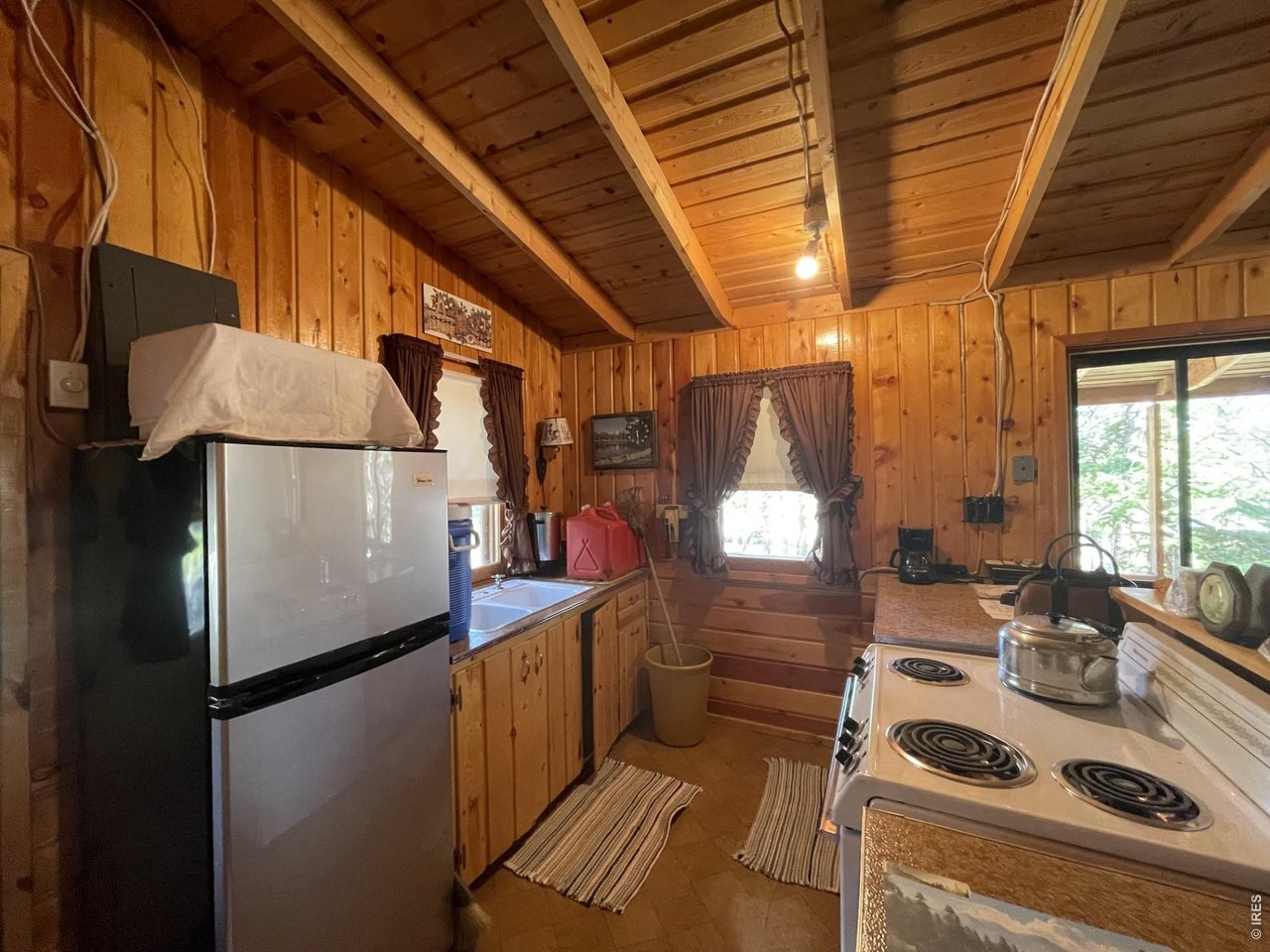 35 Robin Path Red Feather Lakes, CO 80545 - Photo 14 of 25 Galley style functional kitchen which opens to the living area.