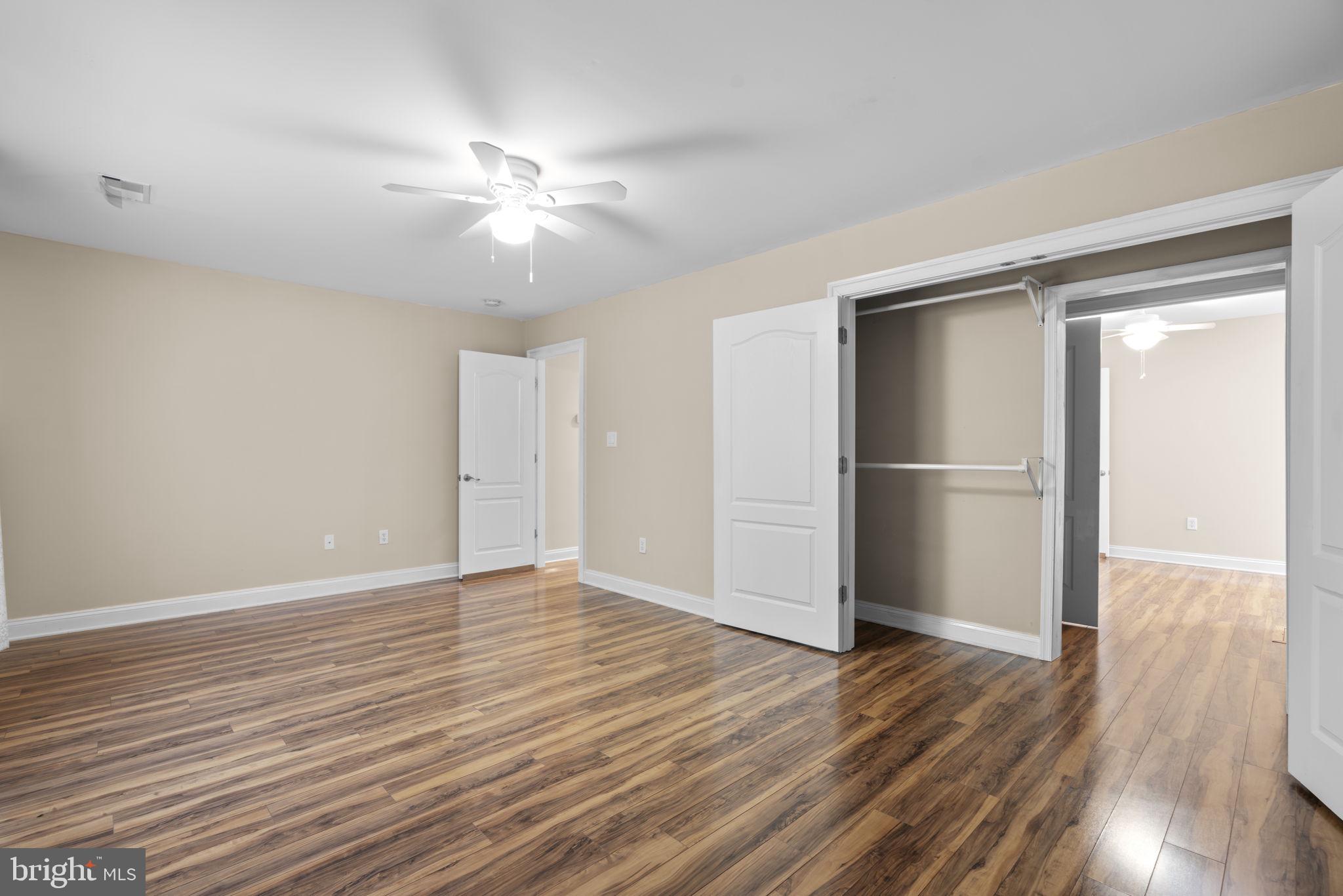 8024 Solley Road Glen Burnie, MD 21060 - Photo 53 of 83 a view of an empty room with wooden floor and a ceiling fan