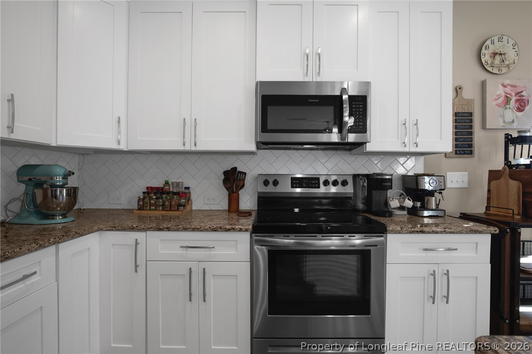 44 Princelet Point Cameron, NC 28326 - Photo 11 of 42 a kitchen with stainless steel appliances granite countertop white cabinets a stove a sink and dishwasher