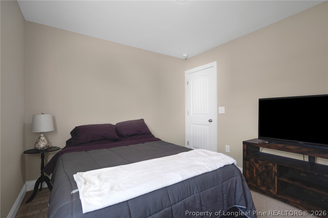 44 Princelet Point Cameron, NC 28326 - Photo 15 of 42 a bedroom with a bed and a flat screen tv