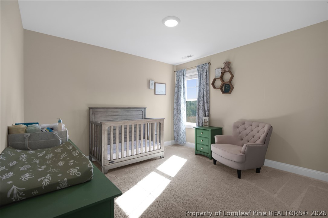 44 Princelet Point Cameron, NC 28326 - Photo 16 of 42 a living room with furniture and a baby crib