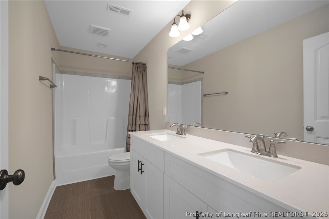 44 Princelet Point Cameron, NC 28326 - Photo 18 of 42 a bathroom with a double vanity sink mirror and toilet