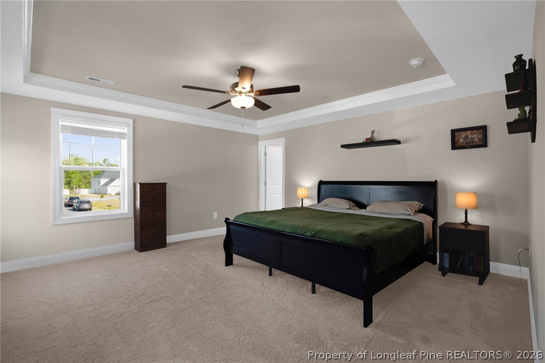44 Princelet Point Cameron, NC 28326 - Photo 22 of 42 a bedroom with a bed and a chandelier