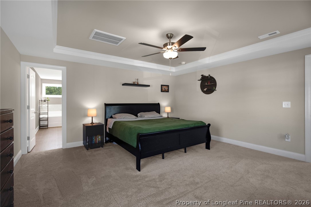 44 Princelet Point Cameron, NC 28326 - Photo 23 of 42 a bedroom with a bed and a ceiling fan