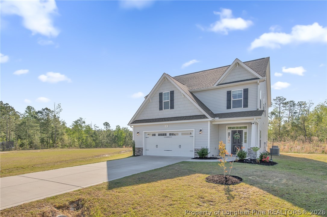 44 Princelet Point Cameron, NC 28326 - Photo 38 of 42 a front view of a house with a yard and garage