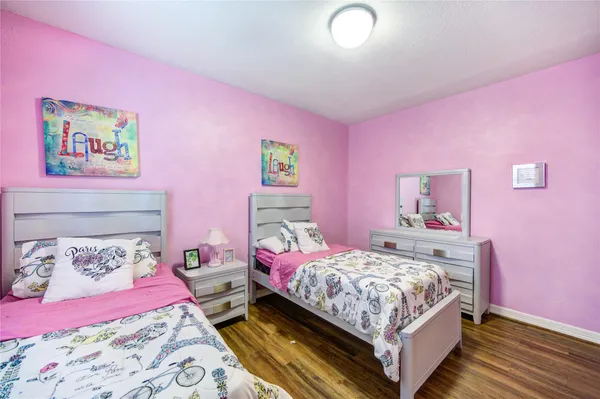 a bedroom with pink walls and pink walls