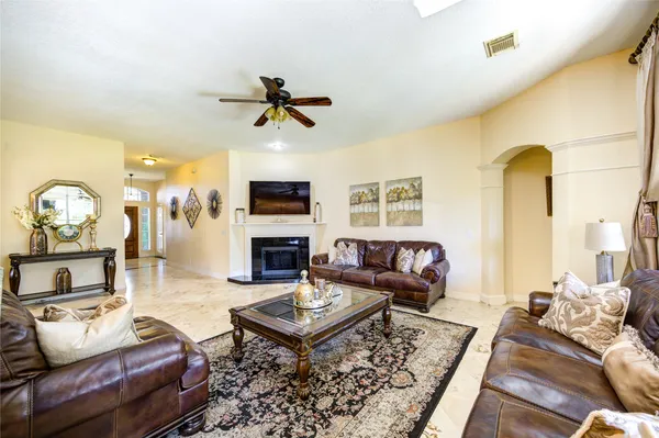 a living room with furniture a rug and a fireplace