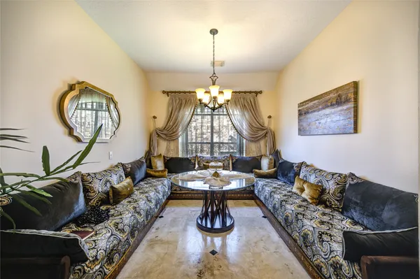 a living room with furniture a chandelier
