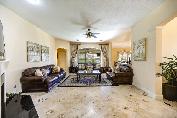a living room with furniture and a chandelier