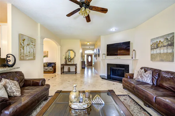 a living room with furniture a fireplace and a flat screen tv
