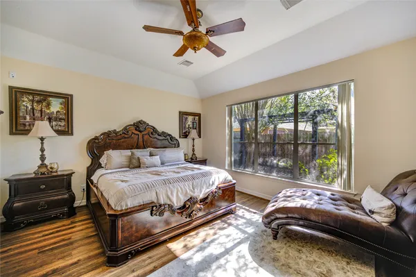 a bedroom with a bed and a large window
