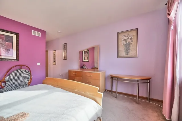 a bedroom with a bed and a chair