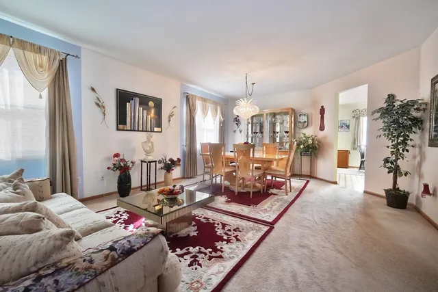 a living room with furniture and a floor to ceiling window