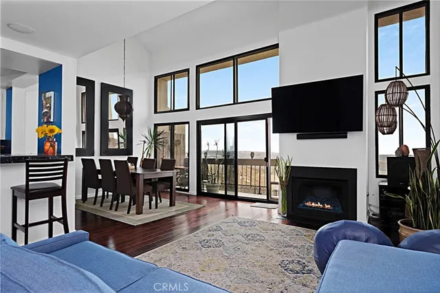 a living room with furniture fireplace and flat screen tv