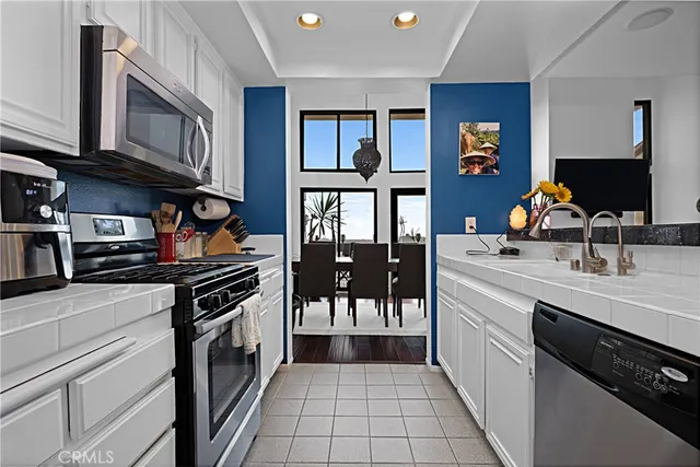 a kitchen with a sink appliances and cabinets