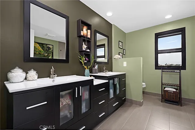 a bathroom with a double vanity sink and a mirror