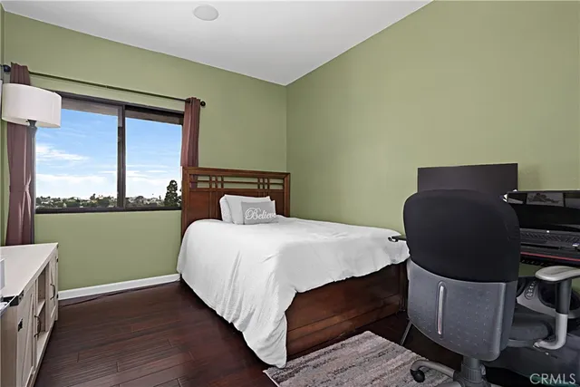 a bedroom with a bed chair and window