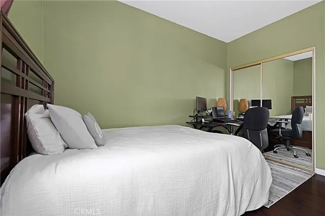 a bedroom with a bed a table and chair