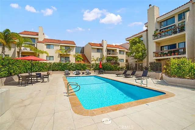 a view of a house with swimming pool and sitting area