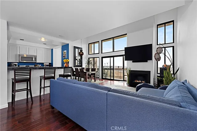 a living room with furniture wooden floor and a fireplace