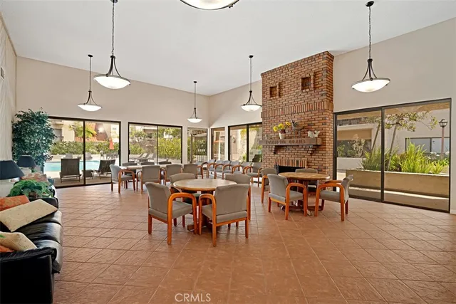 a view of a dining room and livingroom with furniture wooden floor a chandelier