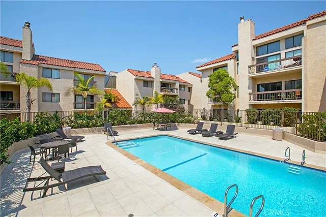 a view of a house with swimming pool and sitting area