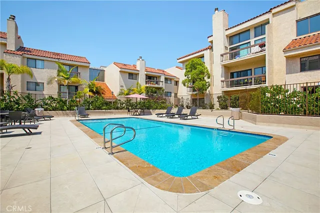 a view of a house with swimming pool and sitting area