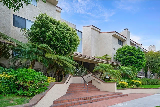 a view of a house with a yard and plants