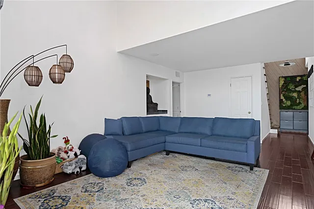 a living room with furniture rug and a window