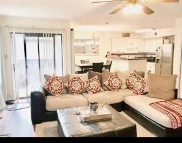 a living room with furniture and a large window