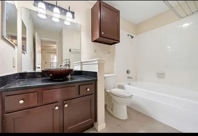 a bathroom with a sink a toilet and bathtub
